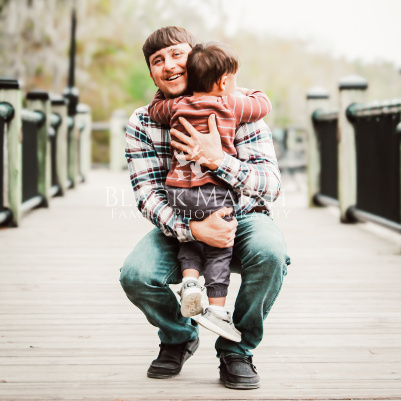 Father catching his son and smiling on the riverwalk in Conway